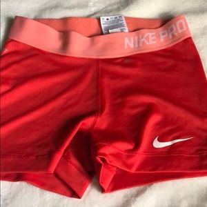 Red and Coral Nike Pros